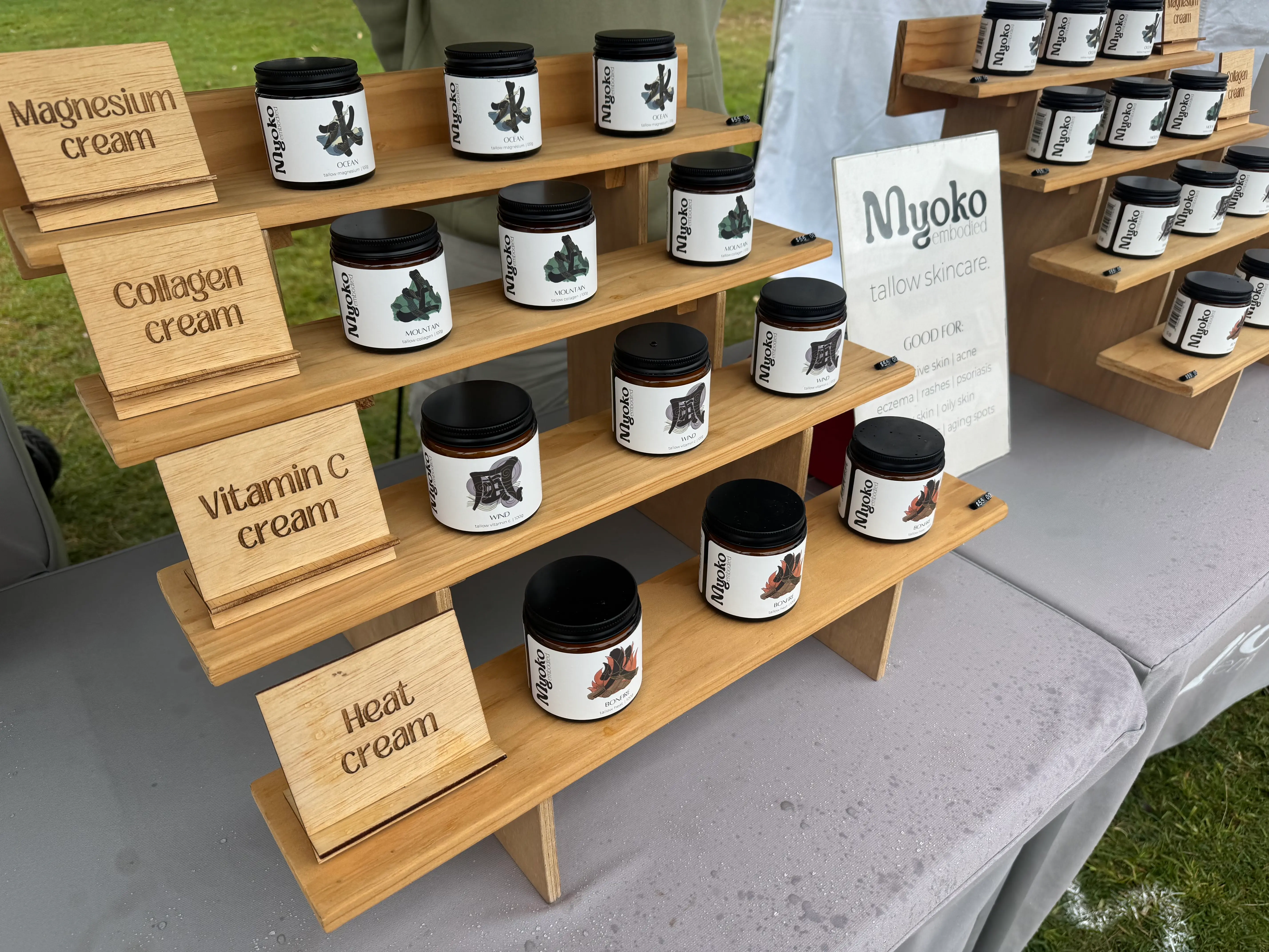 Close view of Myoko Embodied products and branding at the Byron Community Market stall