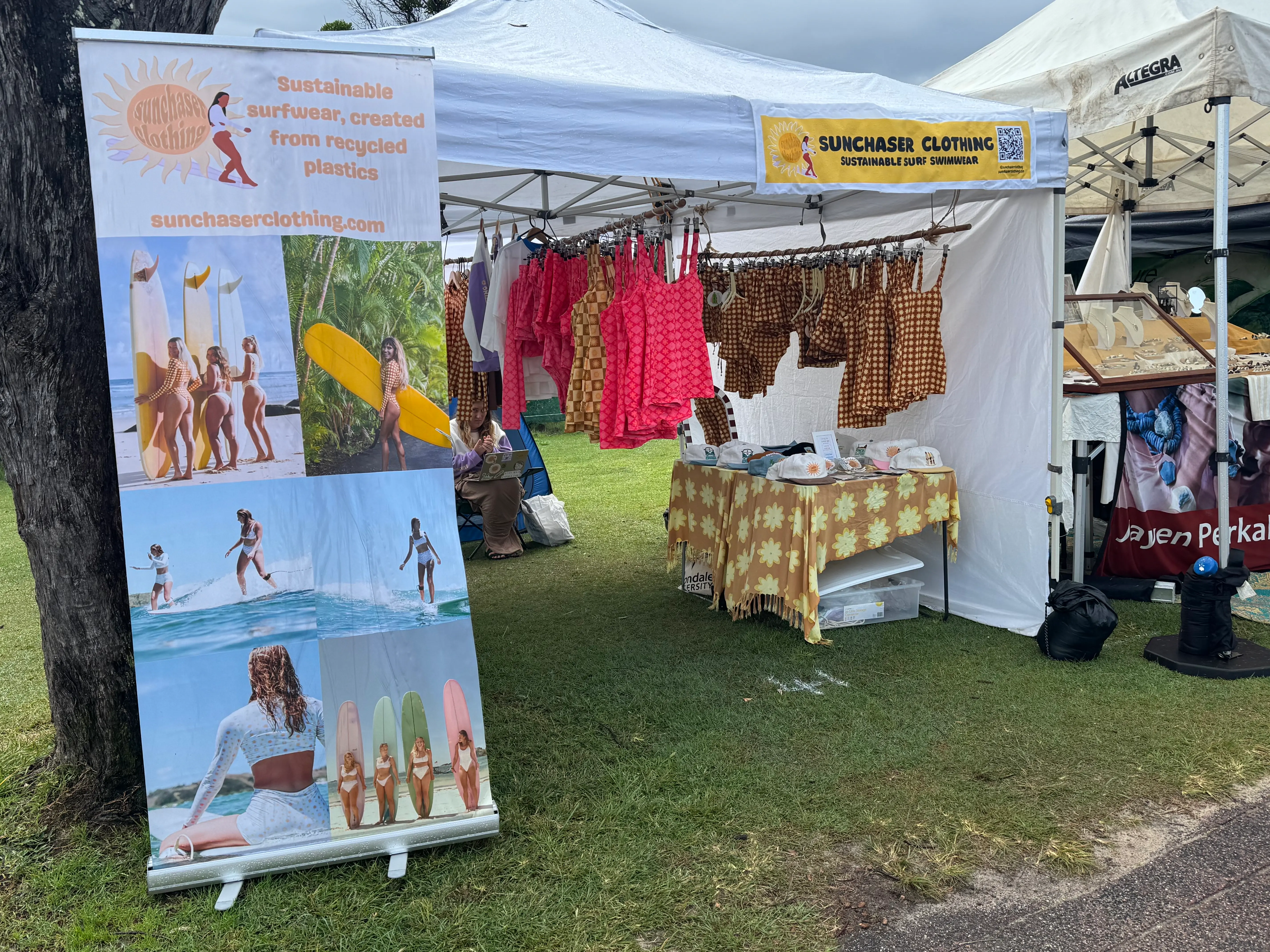 Sunchaser Clothing stall at Byron Community Market with sustainable swimwear displayed