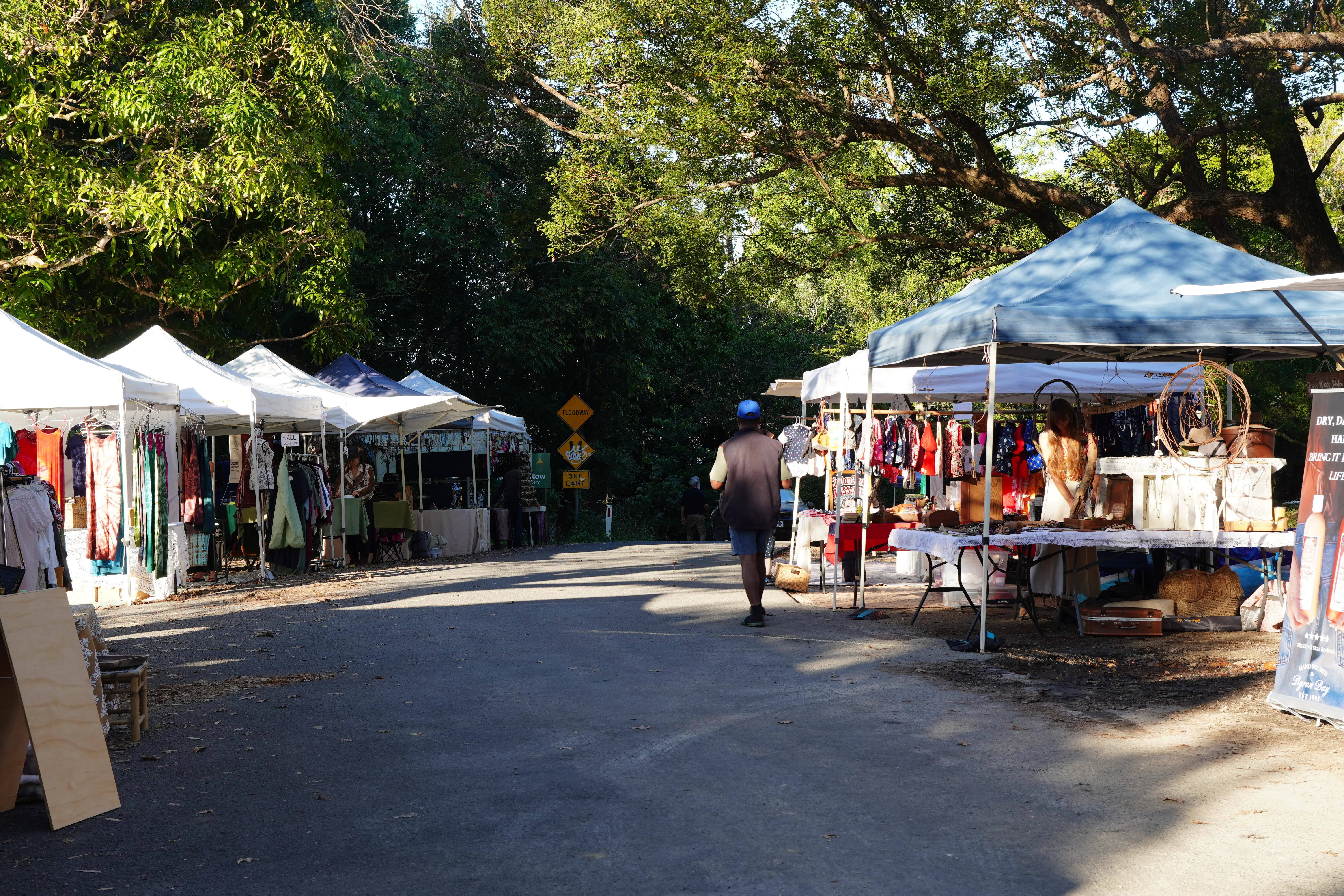 People walking past market stalls at Mullumbimby Community Markets