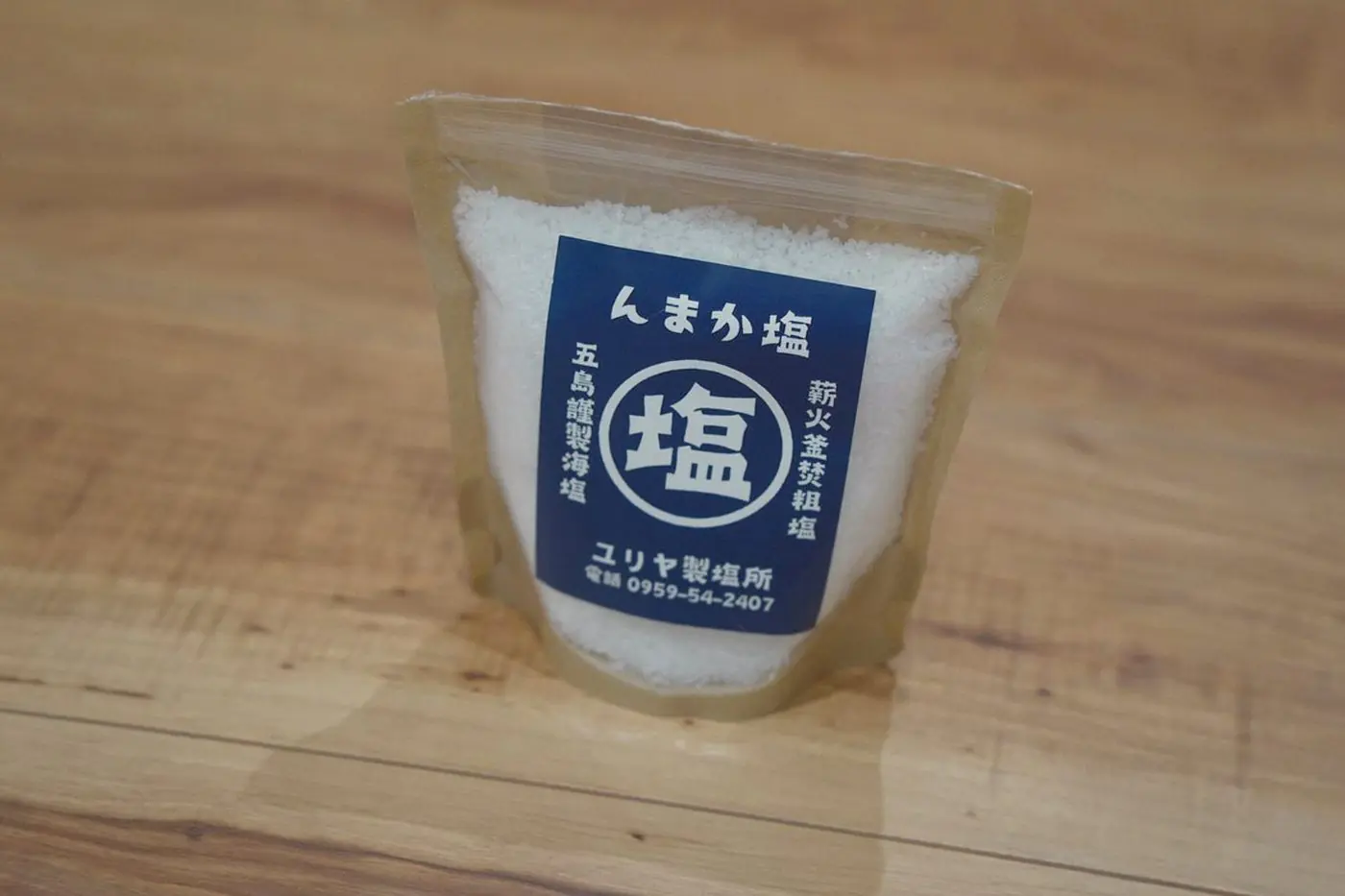 A pouch of Nmaka salt from Yuriya salt works, with coarse white crystals.