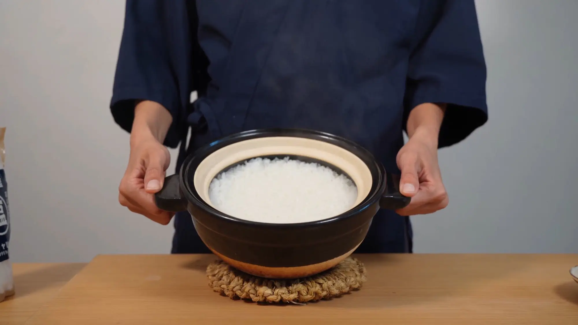 A donabe pot of freshly cooked, glistening white short-grain rice still steaming